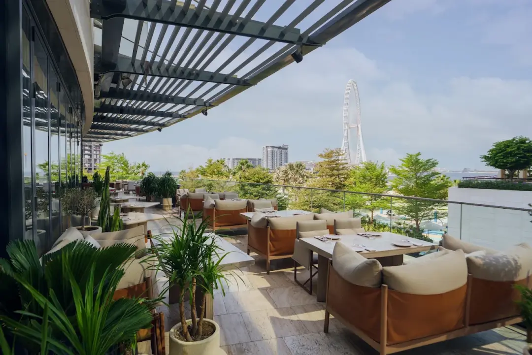The terrace at OSH Del Mar in daylight, facing Dubai Marina