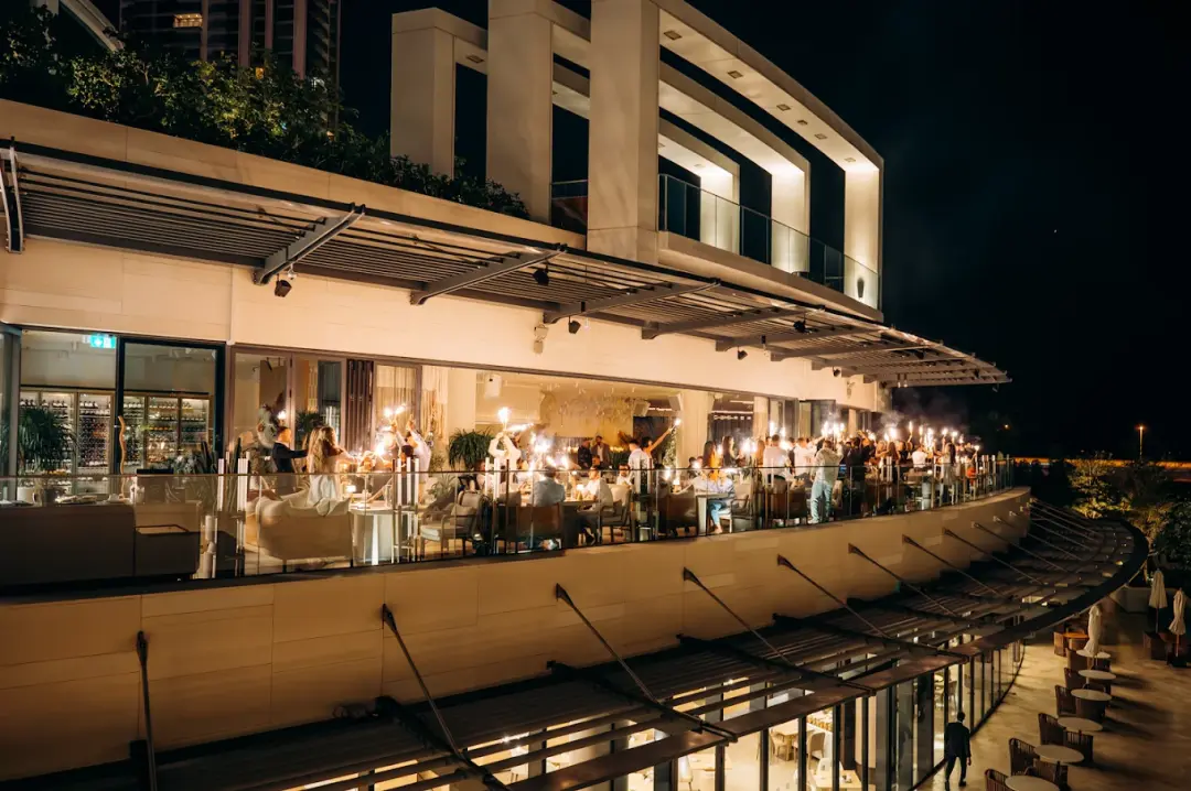 The terrace at OSH Del Mar lit up in the evening